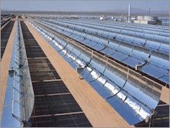 Parabolic trough-based ST plant, in which part of the power generation facility is seen in the background. Reflectors must be spaced out to