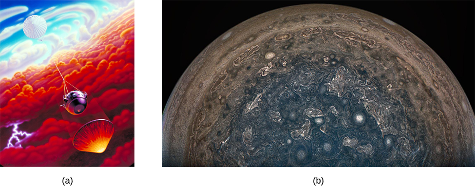 Artist’s depiction of the Galileo Probe entering Jupiter’s atmosphere. At upper left the parachute is seen, connected by a cable to the spherical-shaped probe near the center of the illustration. At lower right, the protective heat shield falls ahead of the probe, protecting it from the heat of entry.