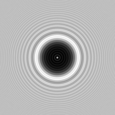 Diffraction image of a two-millimeter circular obstacle with a central bright Arago spot and surrounding rings.