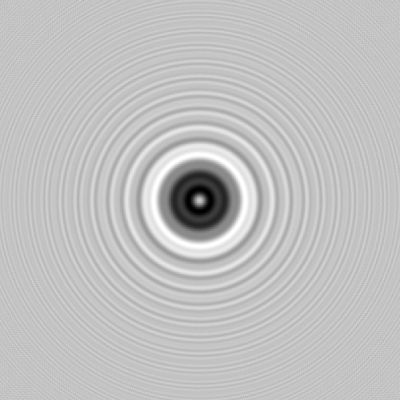Diffraction image of a one-millimeter circular obstacle with a central bright spot and pronounced surrounding rings.