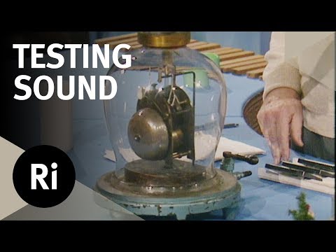 A ringing electric bell sits beneath a glass vacuum chamber.