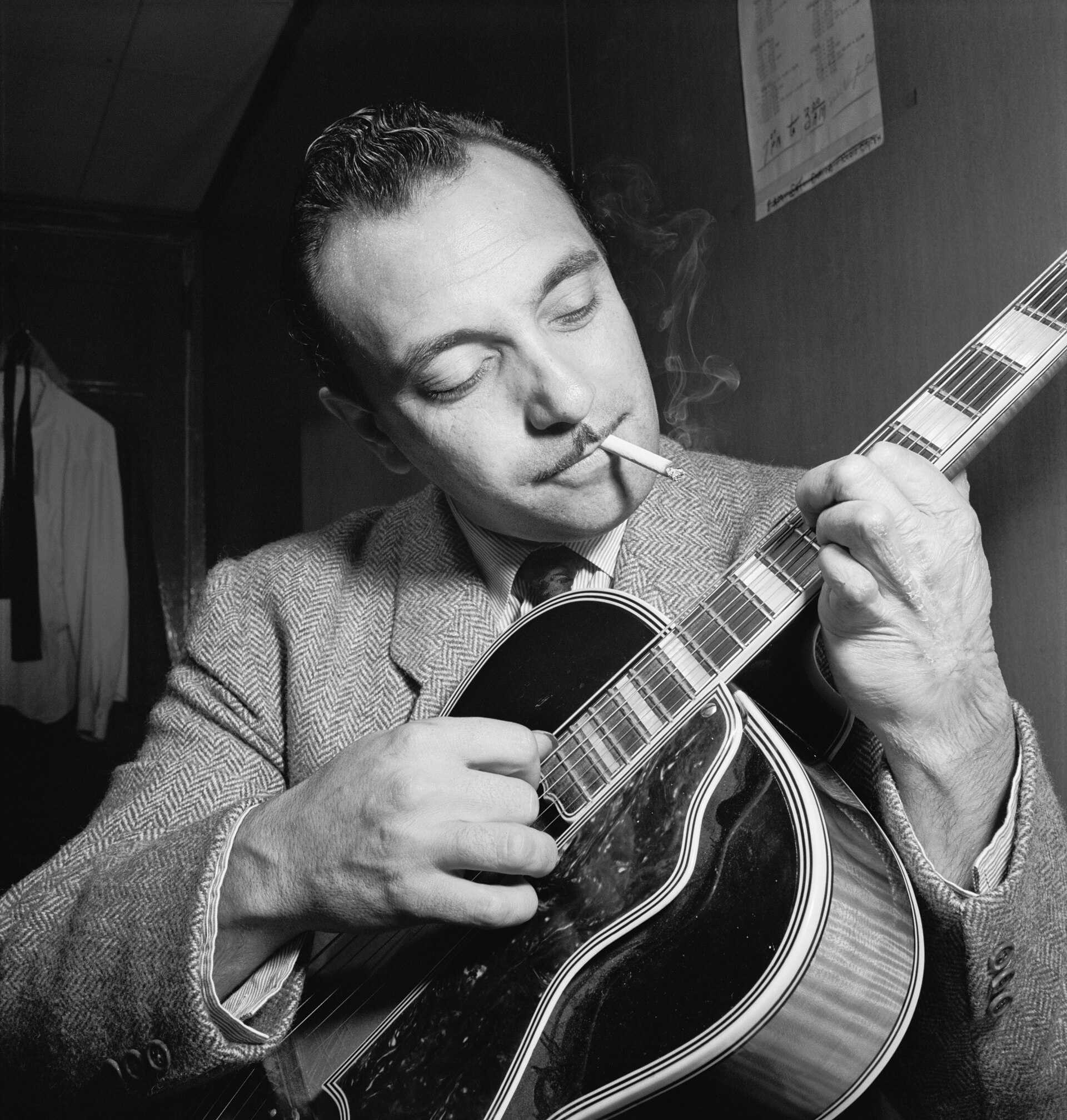 Django Reinhardt playing a guitar.