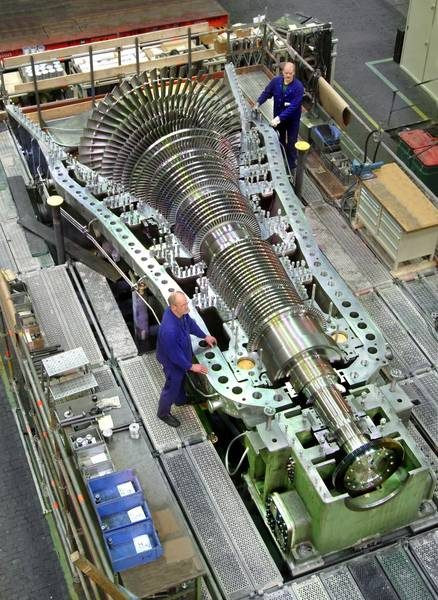 Turbine of a medium-sized steam power plant. As the water passes through the turbine, it loses energy in the form of work and its specific volume increases, requiring increasingly larger blades.