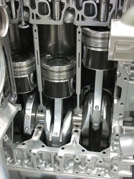 Cutaway view of pistons and cylinders of an automobile engine.
